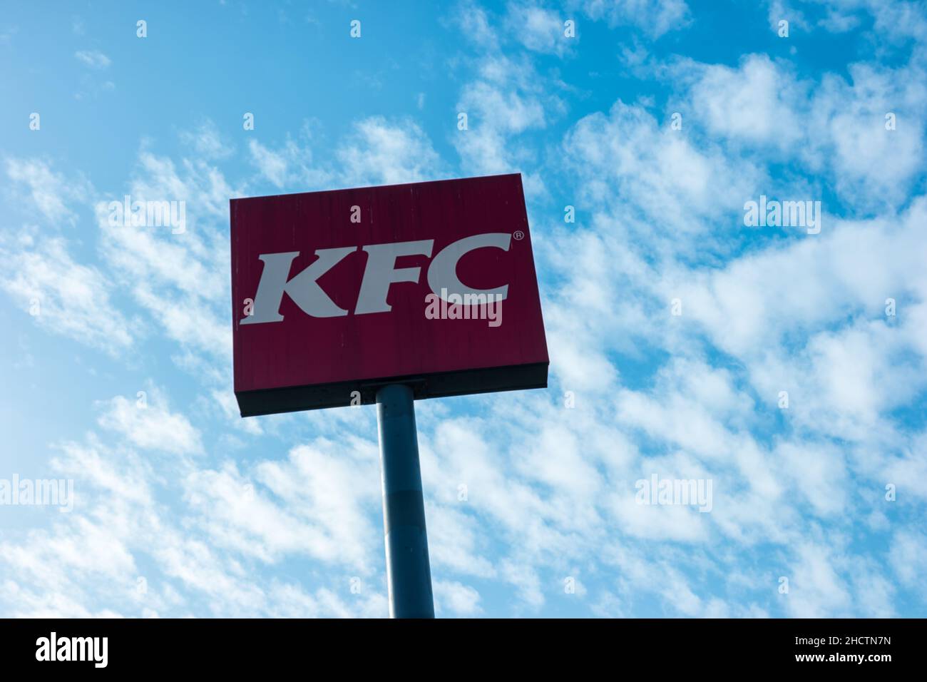 Kentucky Fried Chicken Restaurant Logo with cloudy sky. It is a fast food restaurant chain headquartered in United States specialized in chicken produ Stock Photo