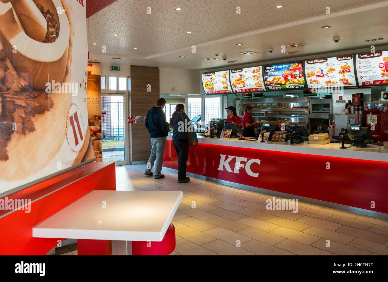 People Order Kentucky Fried Chicken In Fast-Food Restaurant. It is a fast food restaurant chain headquartered in United States specialized in chicken Stock Photo