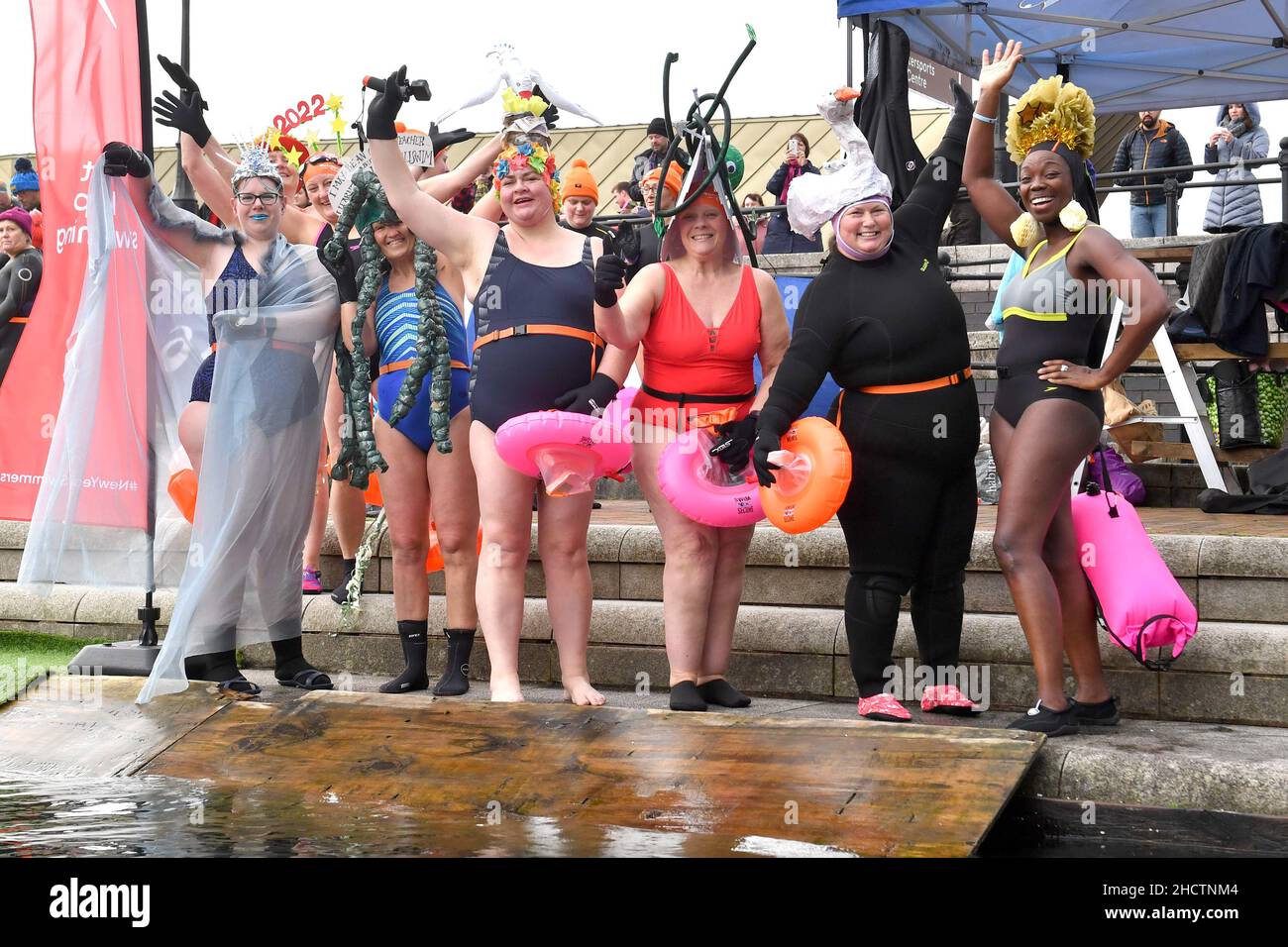 EDITORIAL USE ONLY Swimmers in costume during the Uswim New Year's Day swim at Salford Quays, which is being supported by Speedo. Picture date: Saturday January 1, 2022. Stock Photo