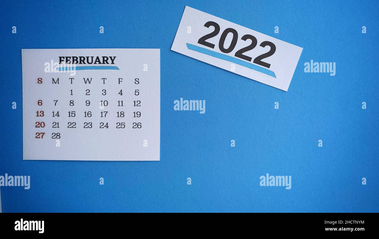 White February 2022 calendar with blue background. 2022 New Year Concept Stock Photo