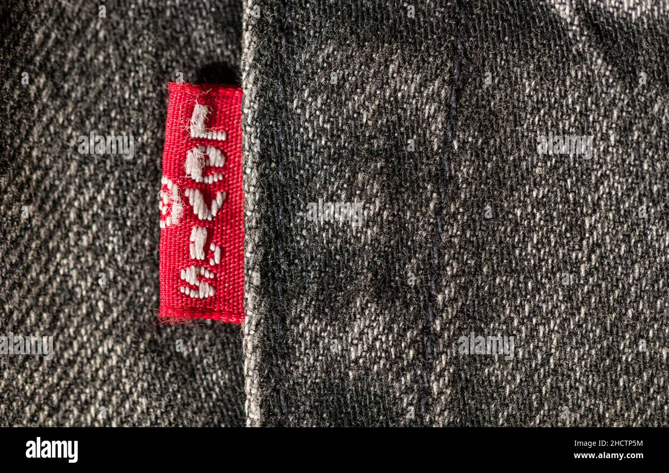 Close up of the LEVI'S label on gray jeans. LEVI'S is a brand name of Levi Strauss and Co, founded in 1853 Stock Photo