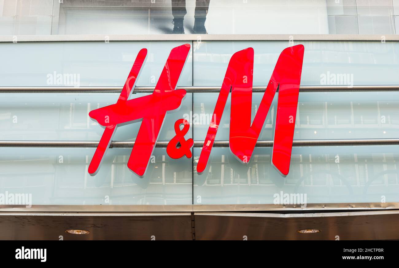 H&M logo on a store. H & M Hennes & Mauritz AB is a Swedish ...