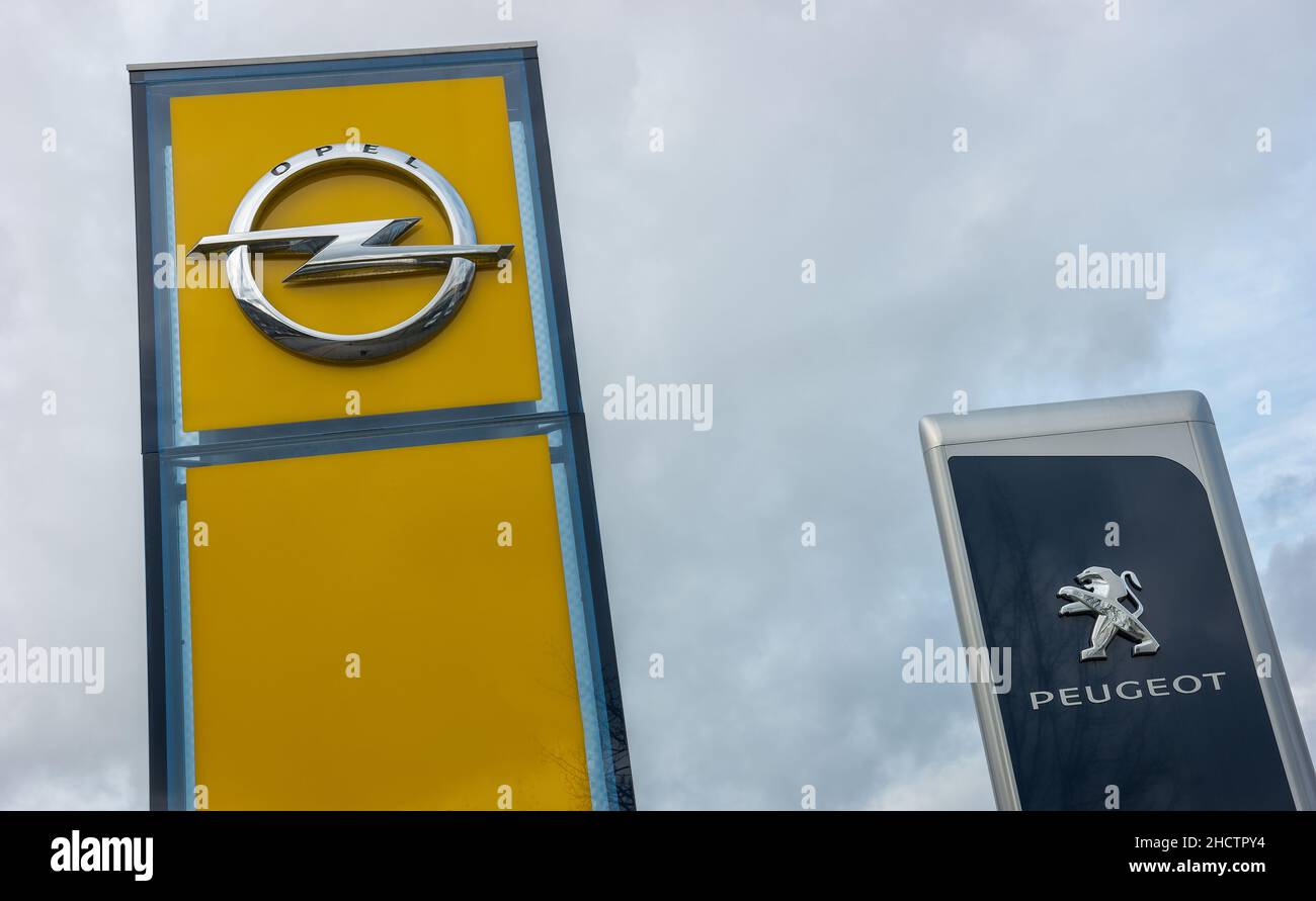 Peugeot dealership sign against cloudy sky. Peugeot is a French automobile manufacturer and part of Groupe PSA. Stock Photo