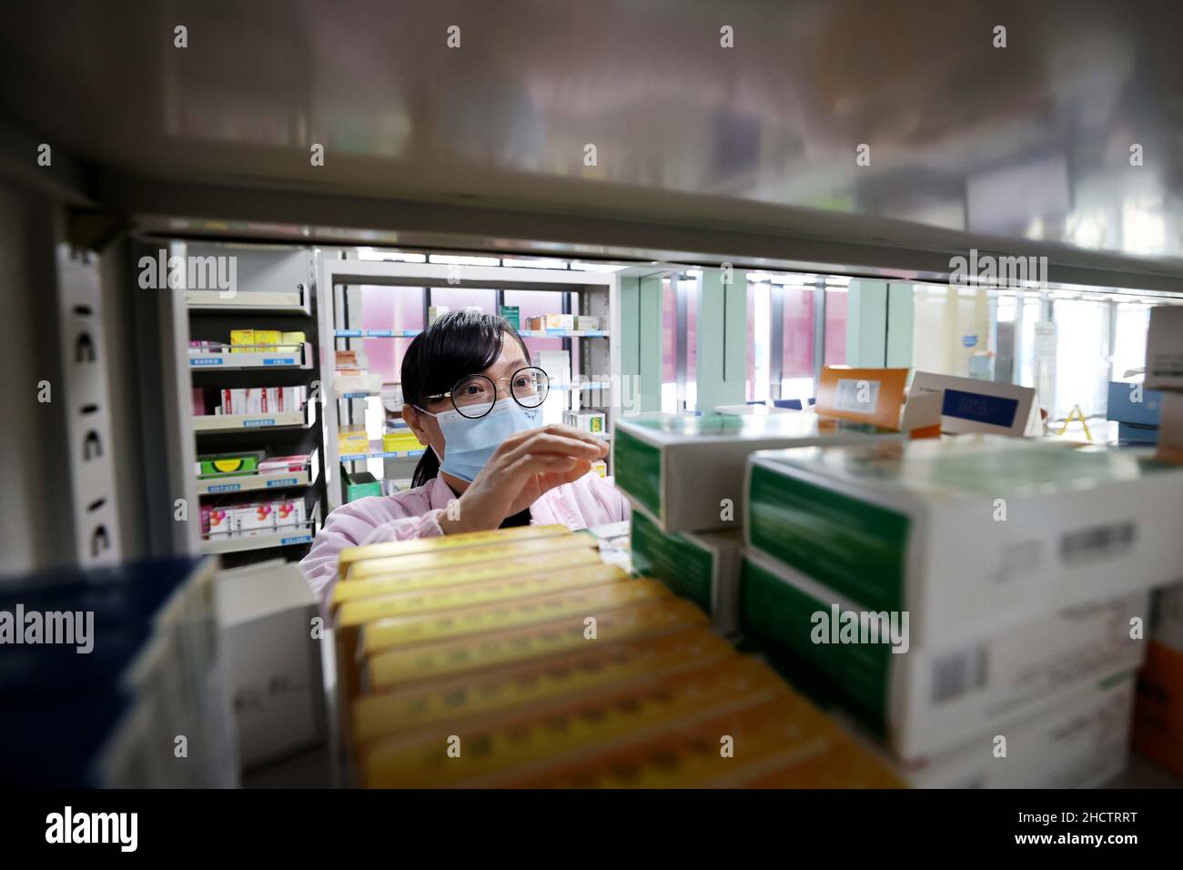 LIUZHOU, CHINA - JANUARY 1, 2022 - A pharmacist fills medicine for a patient at the pharmacy of Rongan County Maternal and Child Health Care Hospital Stock Photo