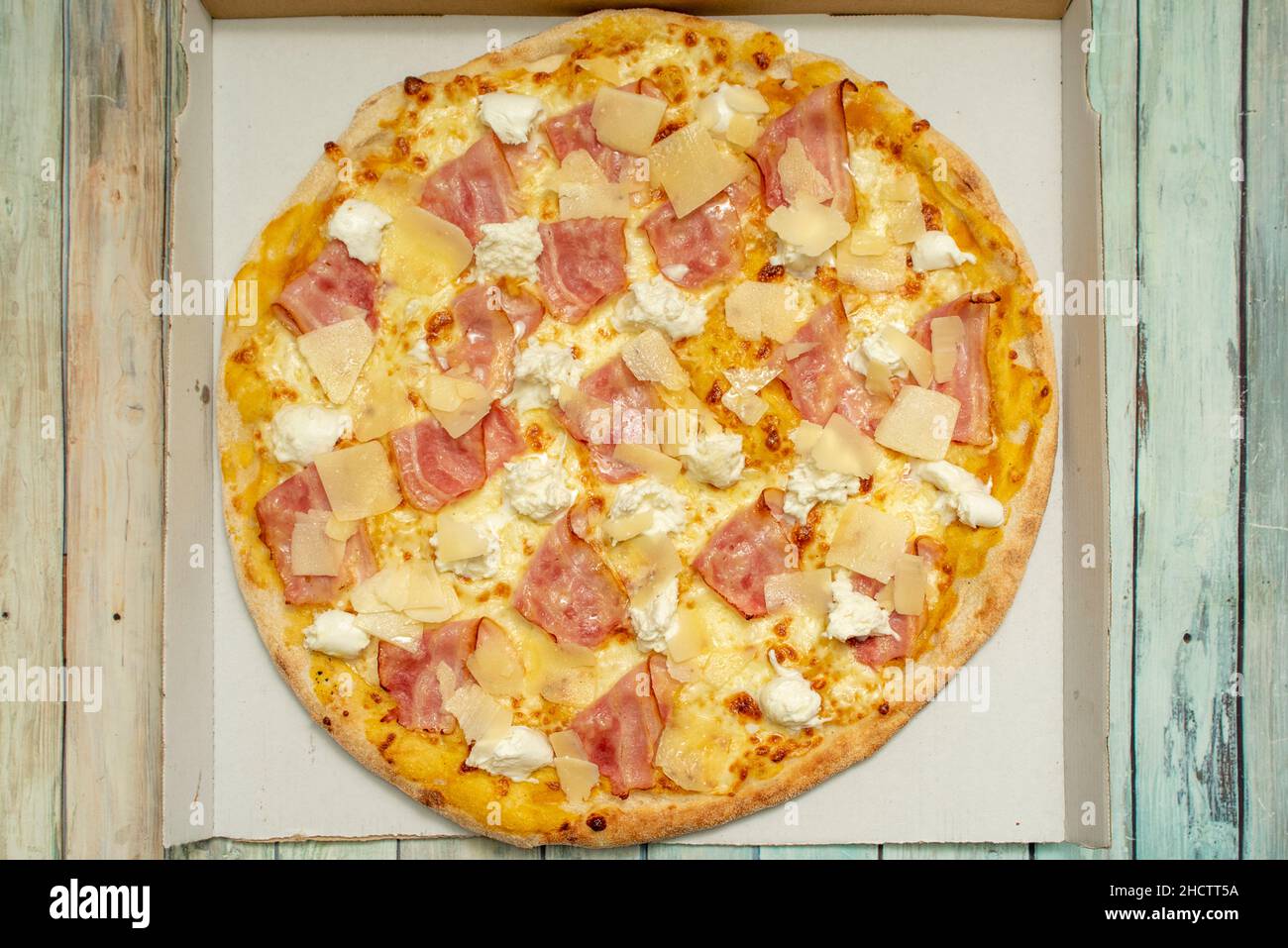 Family cheese and ham pizza with lots of mozzarella and lots of