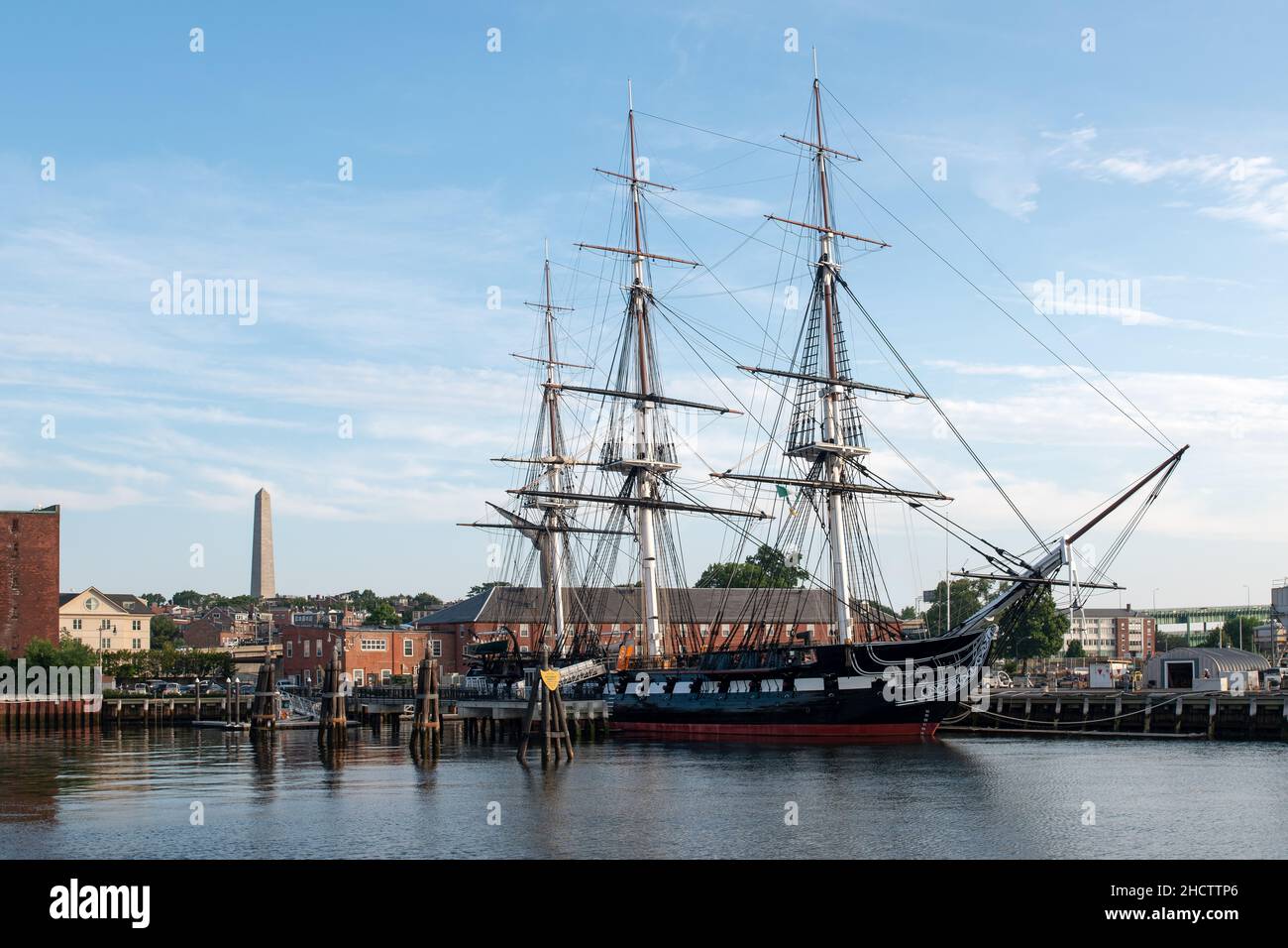 The Oldest ship afloat of any kind in the world, The USS Constitution, 'Old Ironsides' anchored in Charlestown, Massachusetts with the Bunker Hill Mon Stock Photo