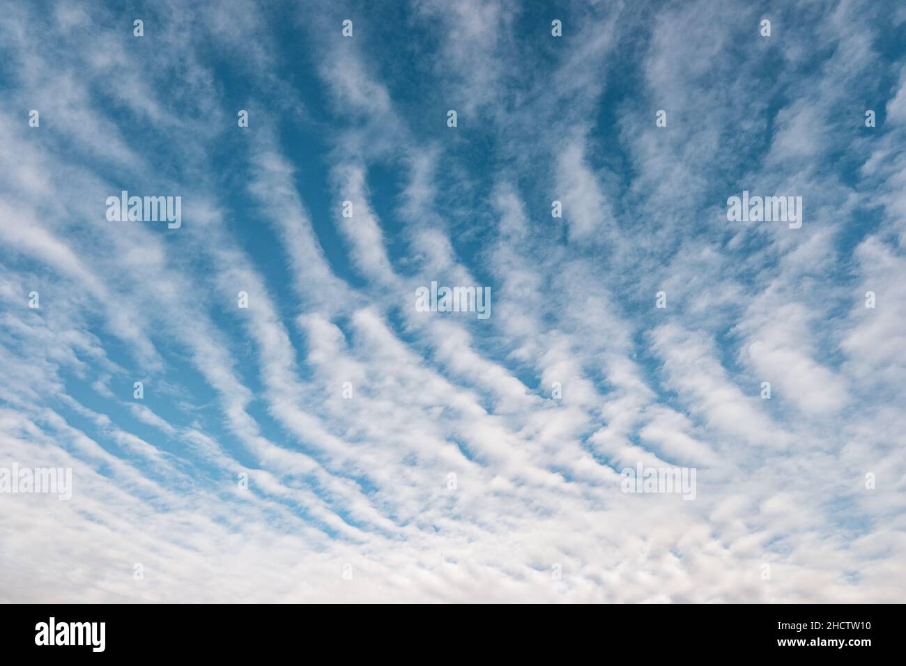 white fluffy rain clouds in the blue sky Stock Photo