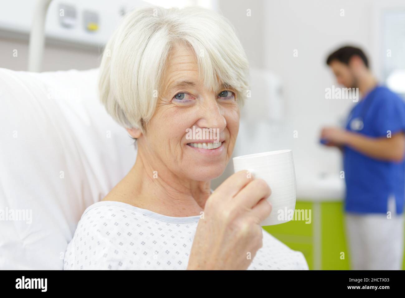 senior female patient drinking coffee on hospital bed Stock Photo Alamy