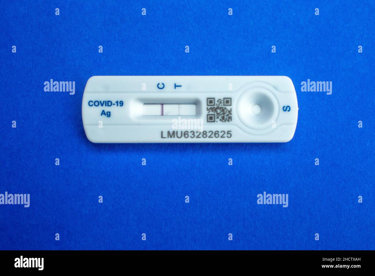 Quick testing for Covid-19 / SARS-CoV-2 infection concept: One rapid antigen test kit showing a positive result (two lines) Stock Photo