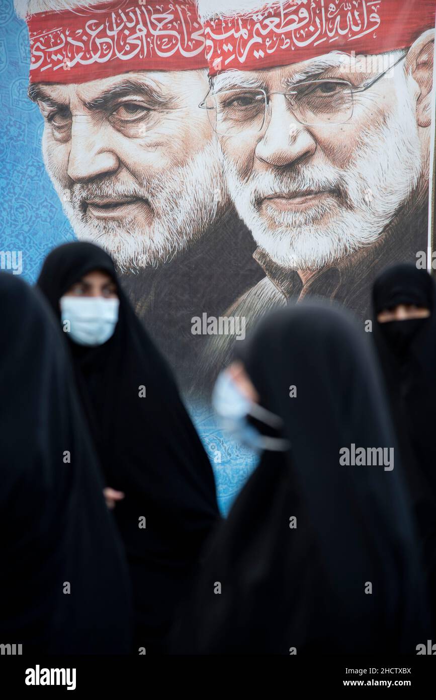Tehran, Iran. 01st Jan, 2022. women walk past the portrait of the Iranian former commander of the Islamic Revolutionary Guard Corps (IRGC) Quds Force, General Qasem Soleimani, and the Iraqi commander of the Popular Mobilisation Forces (PMF) Abu Mahdi al-Muhandis during the gathering of Qasem Soleimani's supporters. the Iranian former Islamic Revolutionary Guard Corps (IRGC) Quds Force General Qasem Soleimani was killed in an American drone attack in Baghdad airport. (Photo by Sobhan Farajvan/Pacific Press) Credit: Pacific Press Media Production Corp./Alamy Live News Stock Photo
