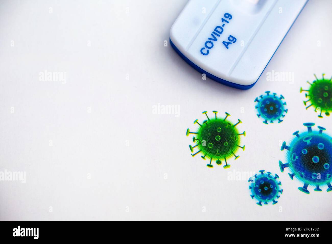 Quick testing for Covid-19 / SARS-CoV-2 infection concept: Models of a coronavirus with Covid-19 Rapid Antigen Self-Testing Stock Photo