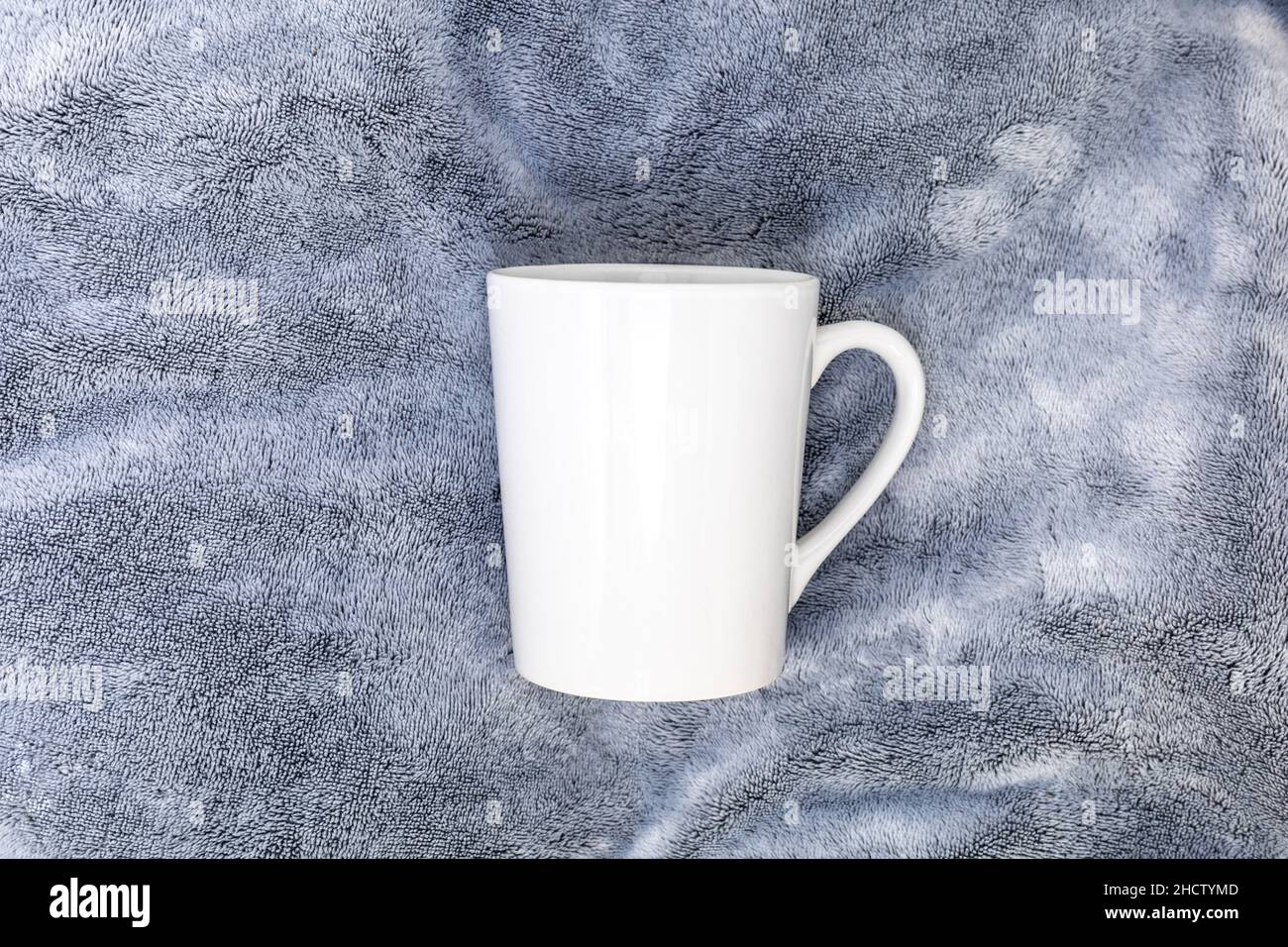 White Mug mockup on plush gray for copy space add your logo Stock Photo