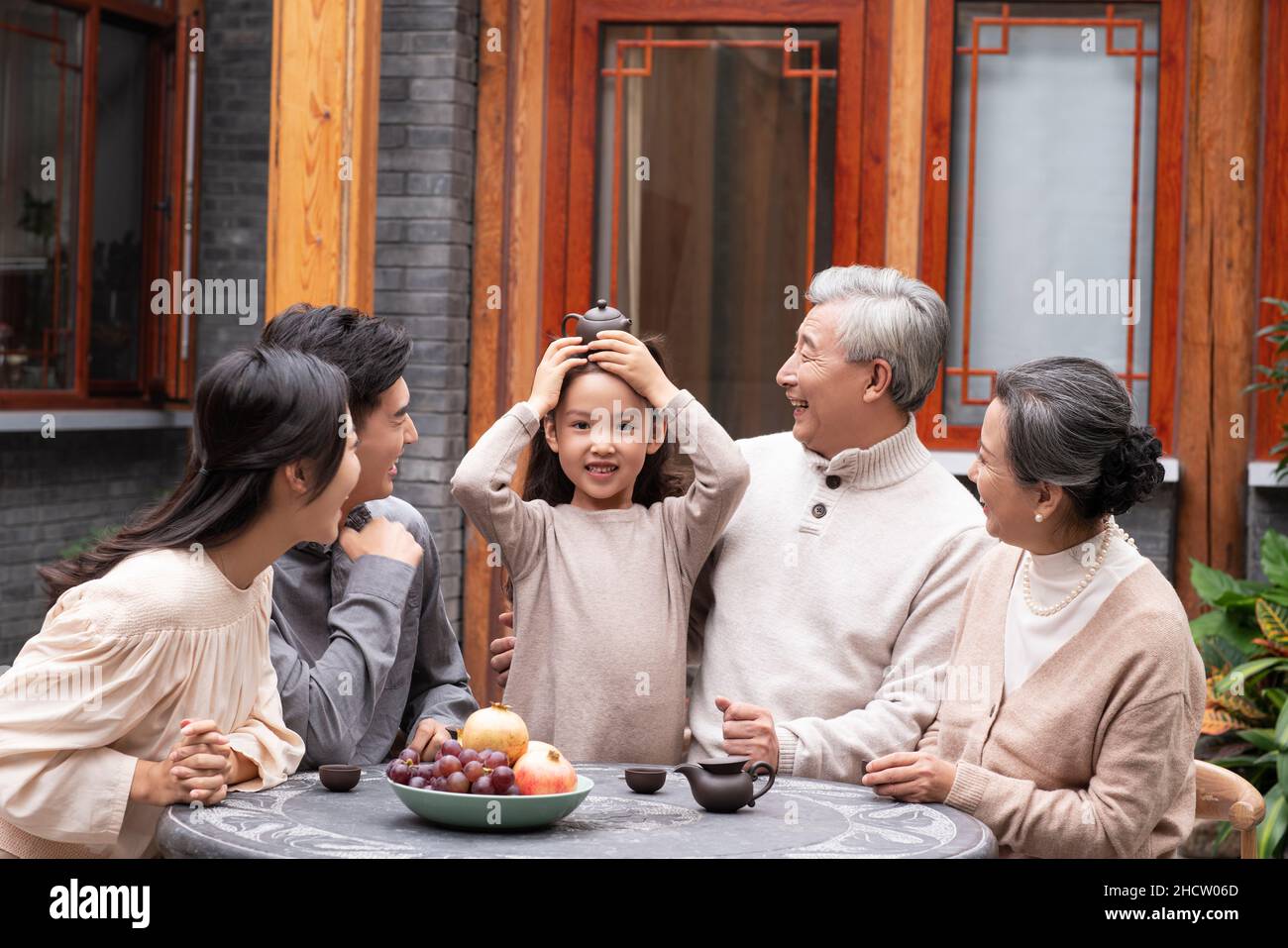 Happy families drinking tea and chatting in the courtyard Stock Photo