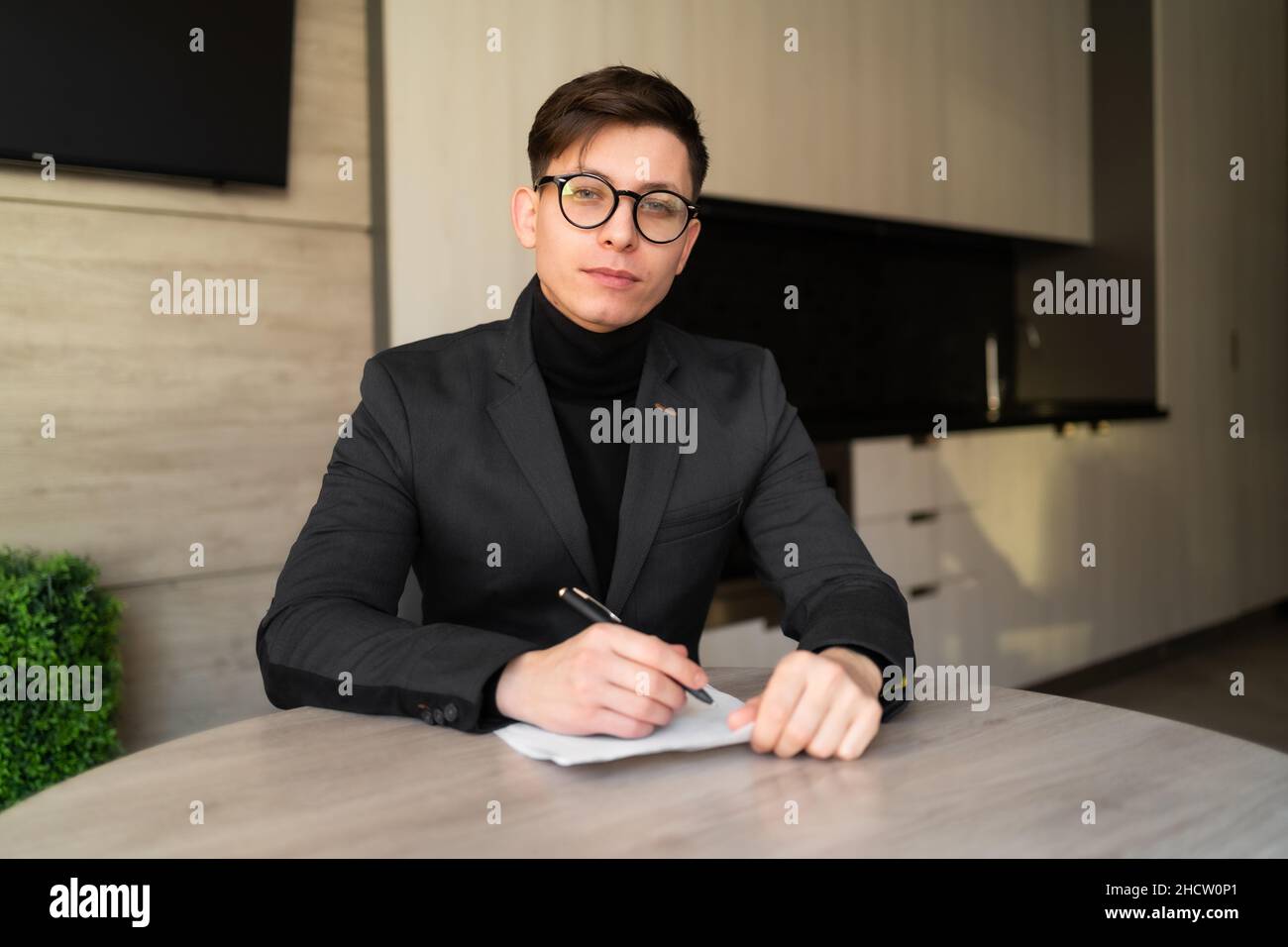 male studying at home online, adult student recording lecture, home schooling concept Stock Photo