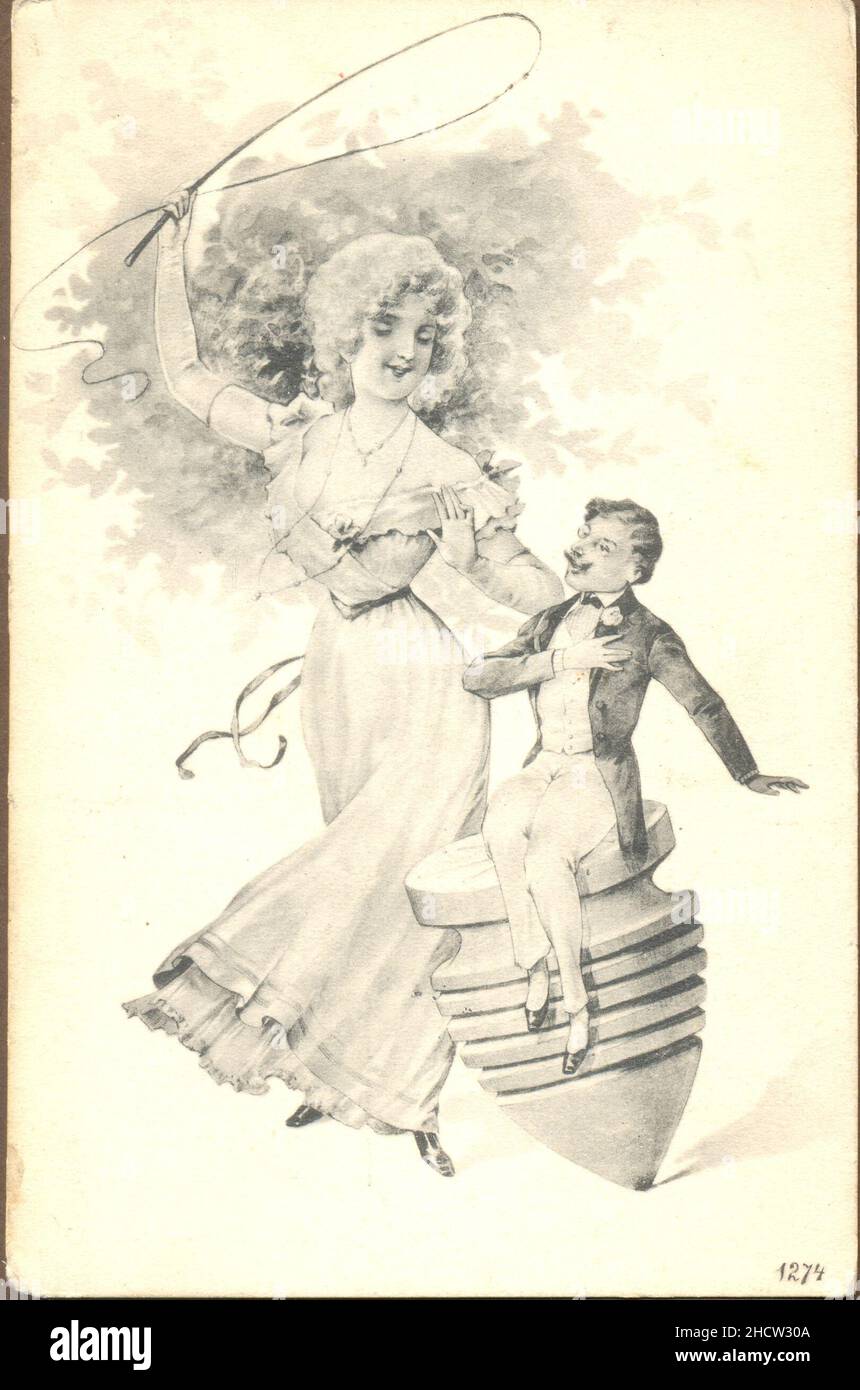 Picture postcard showing domineering woman taking whip to man seated on spinning top circa 1903 Stock Photo