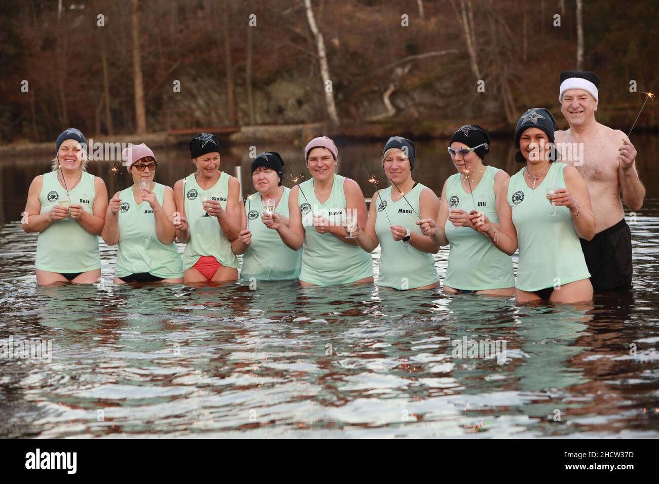 Hasselfelde, Germany. 01st Jan, 2022. The 'Eisperlen aus Hasselfelde' (ice pearls from Hasselfelde) welcome the new year with a swim in the ice-cold bathing lake. Nine brave women and one man lined up for the swim. The ice pearls regularly go into the water during the cold season. Ice bathing is supposed to protect the immune system and prevent colds. Credit: Matthias Bein/dpa-Zentralbild/dpa/Alamy Live News Stock Photo