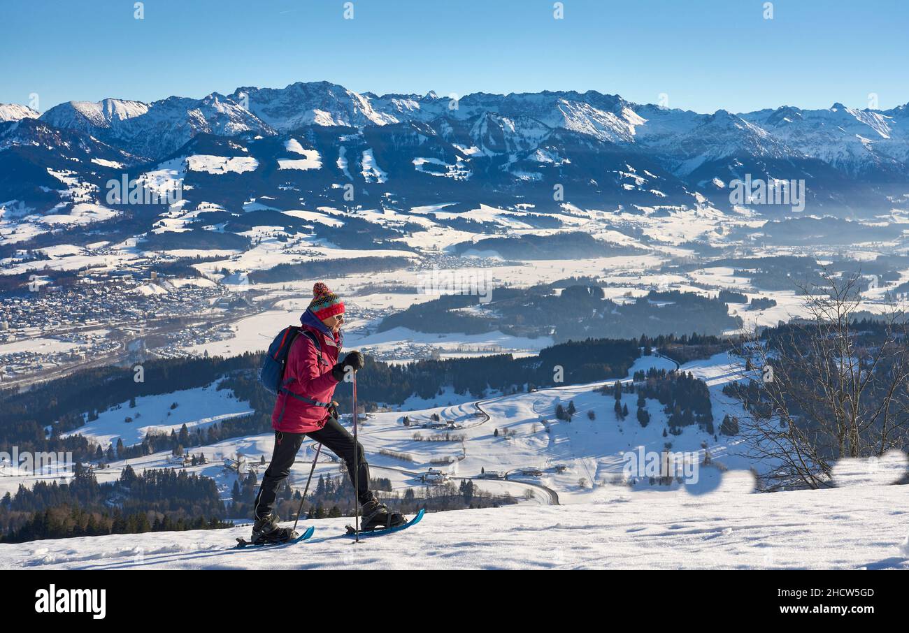 nice and active senior woman snowshoeing in in the Allgau alps above Immenstadt, Bavaria, Germany Stock Photo