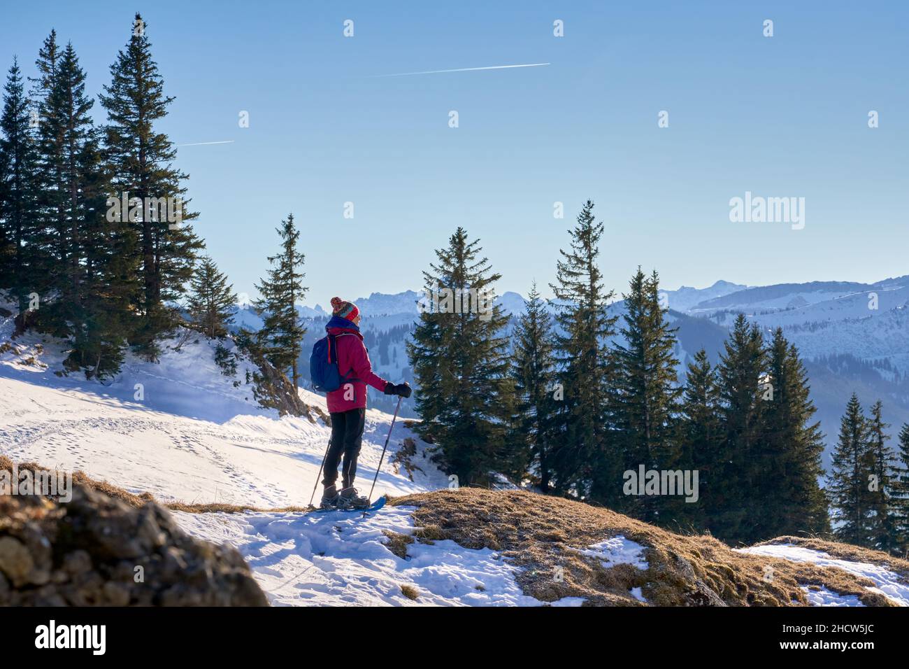 nice and active senior woman snowshoeing in in the Allgau alps above Immenstadt, Bavaria, Germany Stock Photo