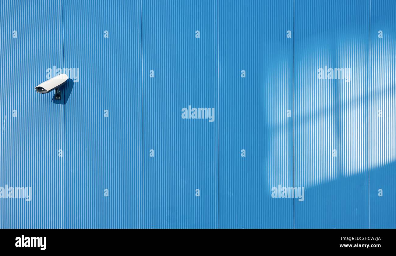 Security camera on the blue wall Stock Photo