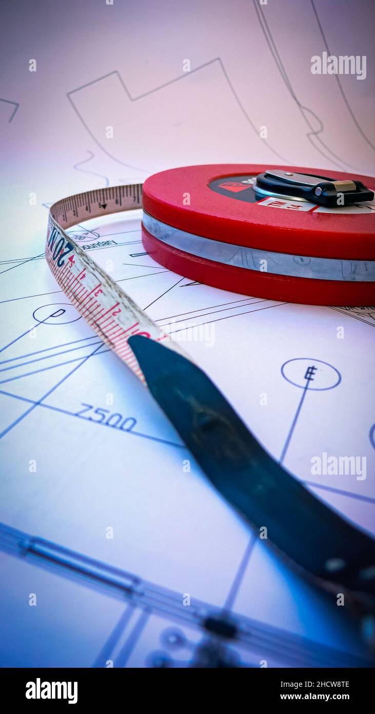 Illustrative editorial image of architectural drawings and measuring