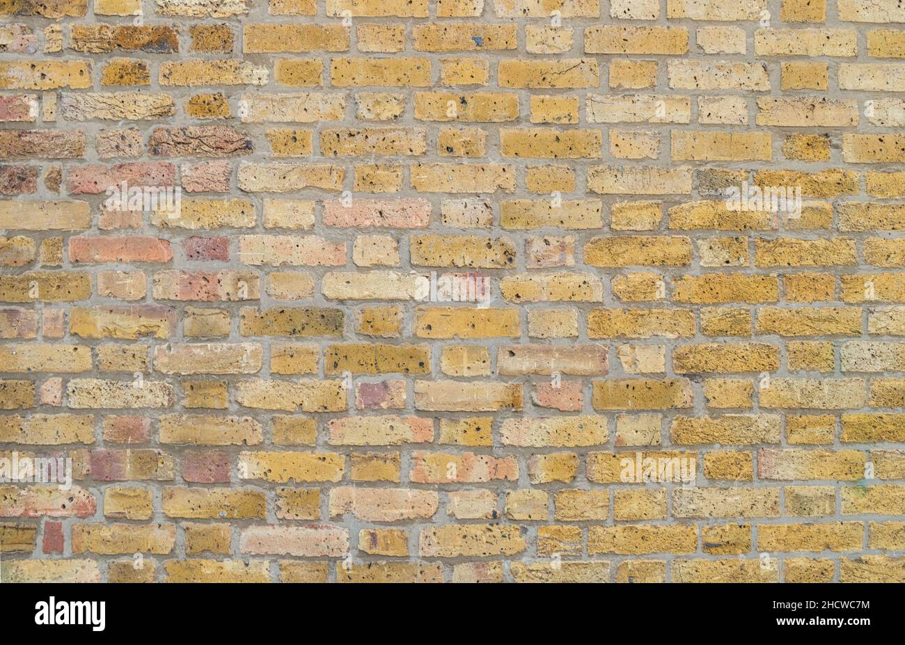 old yellow brick wall Background texture Stock Photo