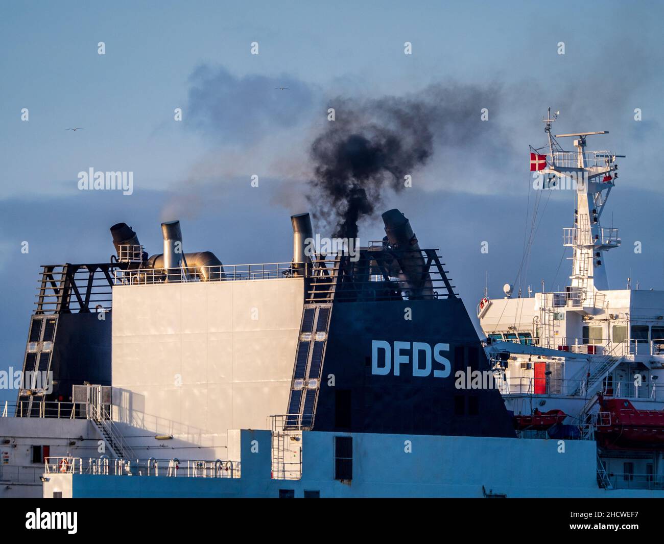 Ship Funnel Pollution - Marine Traffic Exhaust Pollution from Ships - diesel smoke from a DFDS Truck Ferry arriving at Felixstowe Port UK Stock Photo