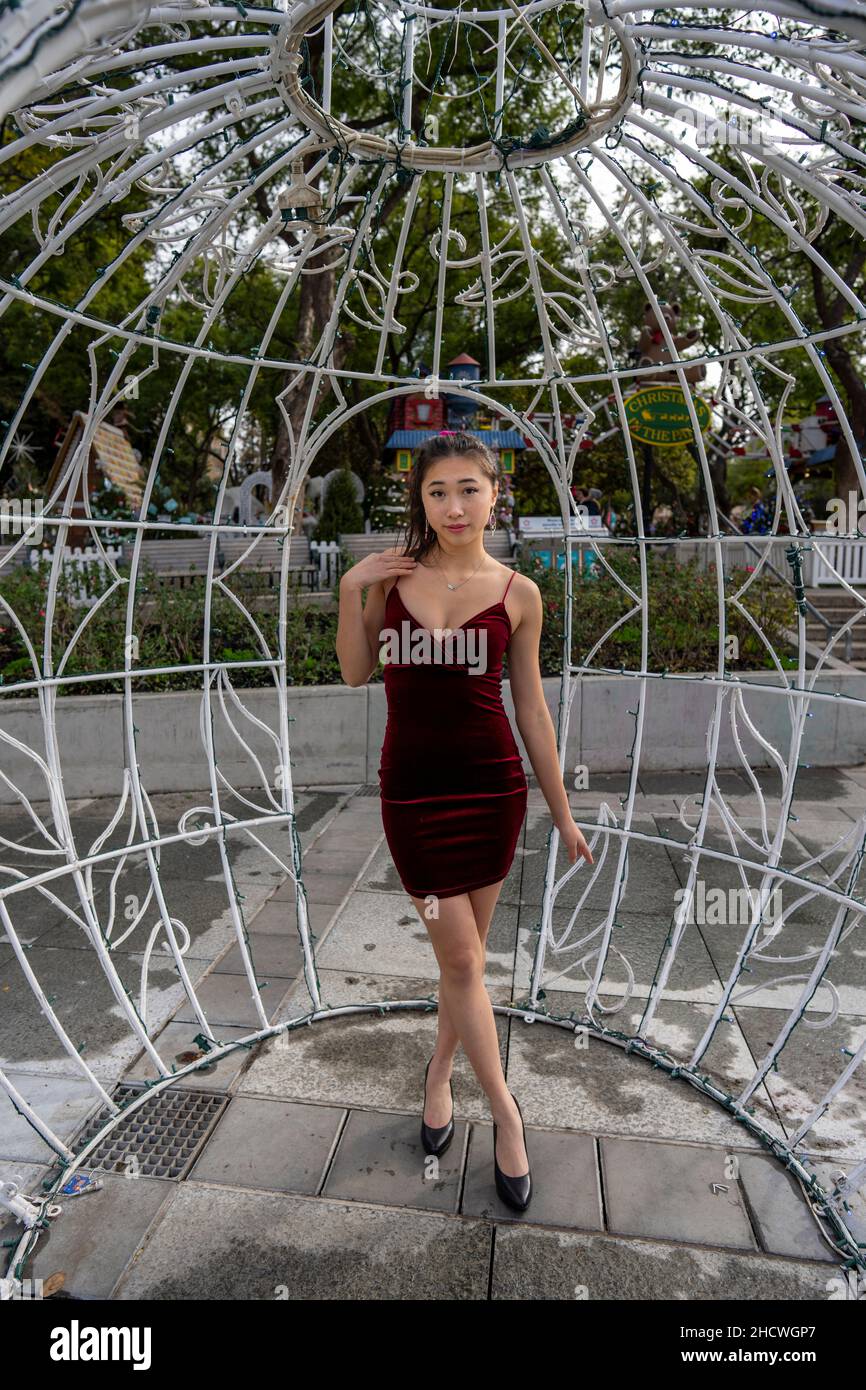 Portrait of Young Asian Woman Inside a Large Christmas Ornament Sculpture Stock Photo