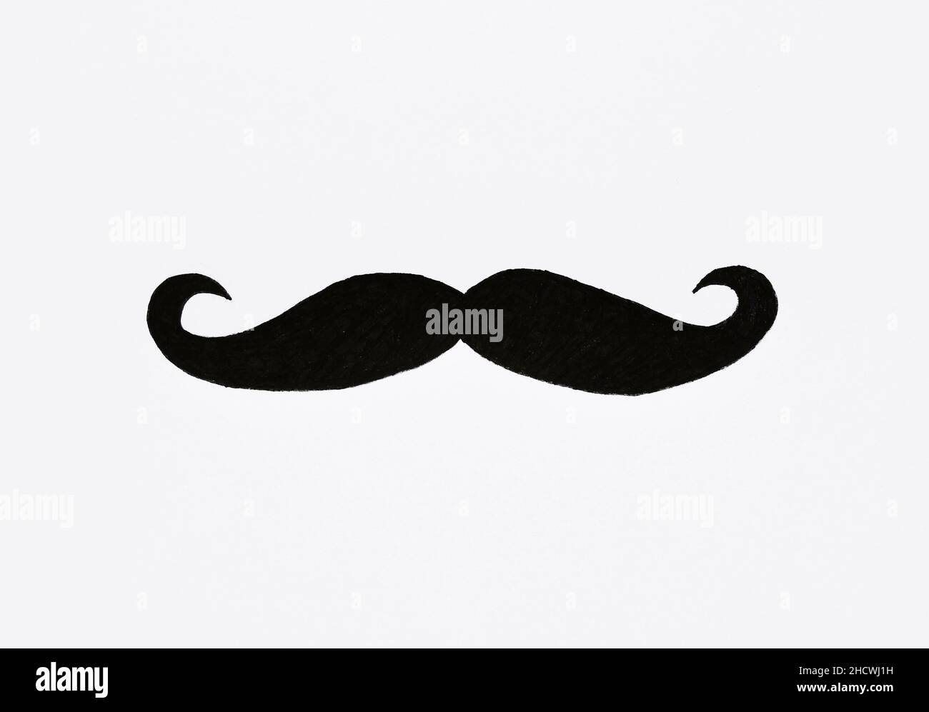 Overhead of a drawing of a moustache on white paper or background Stock Photo