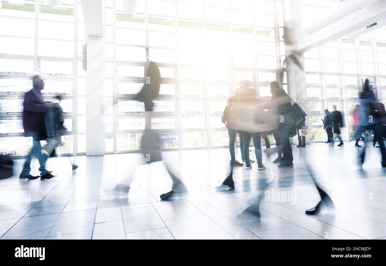 abstakt image of people walking in the corridor of an business center ...