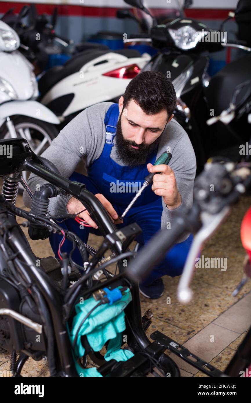 Motorcycle Service Work Worker fixing motorbike hi-res stock photography and images - Alamy