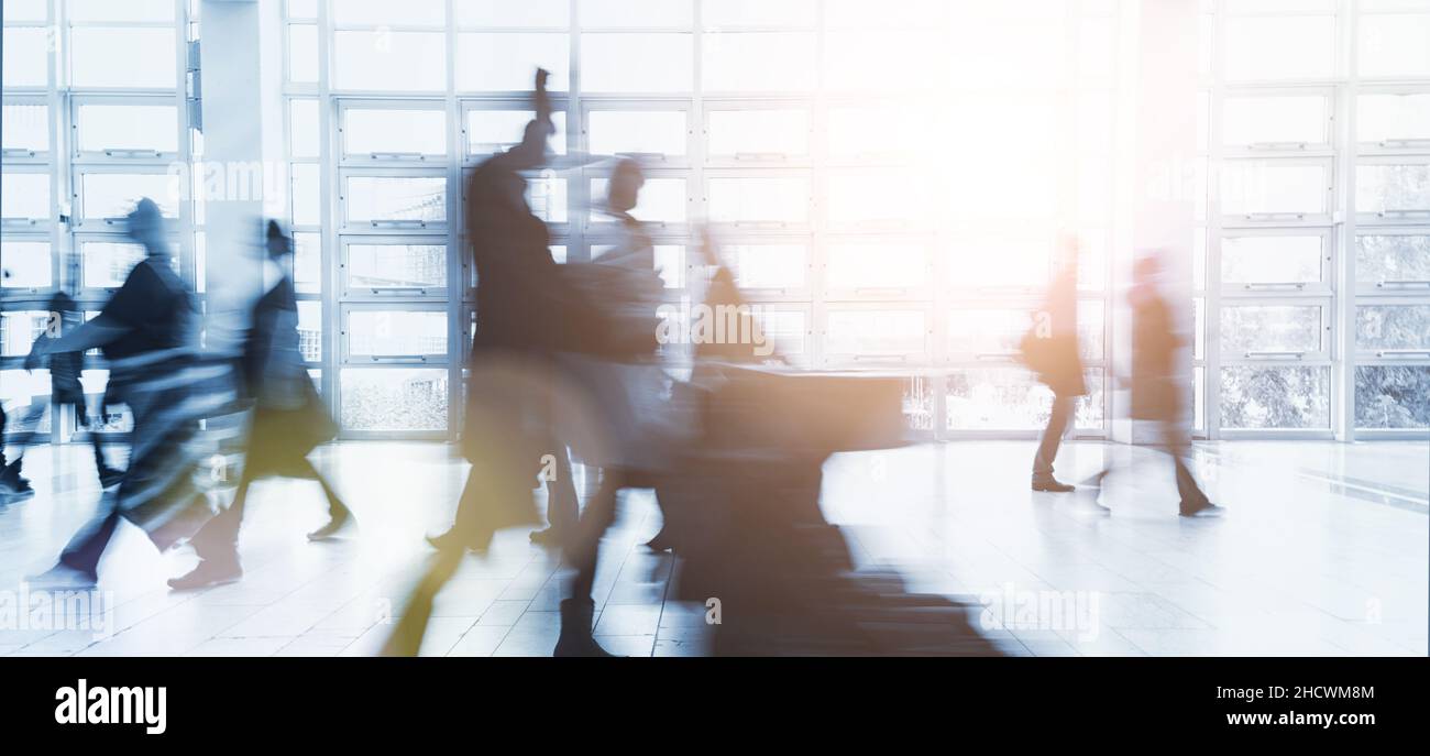 blurred business people walking in a modern environment Stock Photo - Alamy