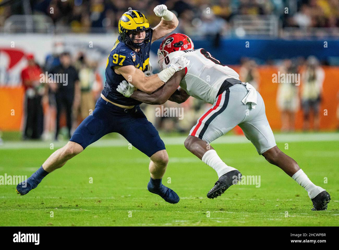 Michigan Wolverines defensive end Aidan Hutchinson (97) tries to get past  Georgia Bulldogs tight end Darnell Washington (0) during the Capital One  Orange Bowl NCAA College Football Playoff game between Georgia and