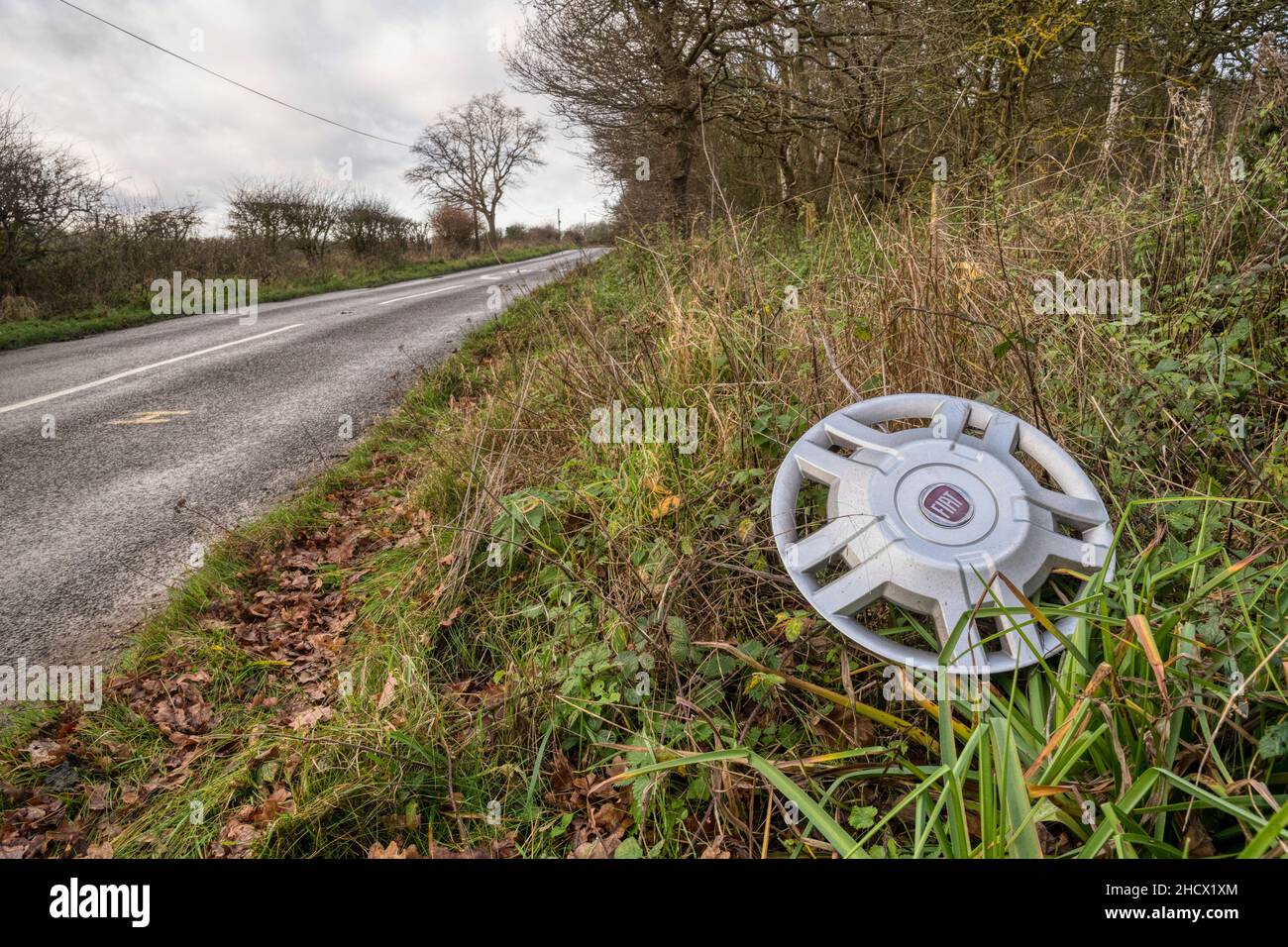 A lost hubcap lying abandoned on a roadside verge in Norfolk. Stock Photo