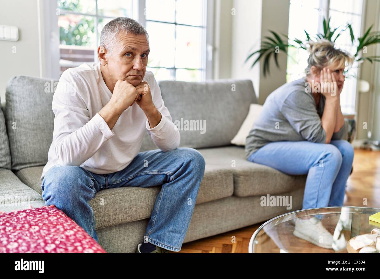 Senior caucasian couple in trouble sitting on the sofa at home Stock ...