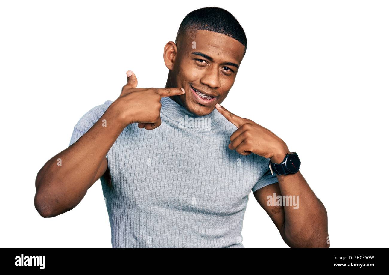 Young black man wearing casual t shirt smiling cheerful showing and ...