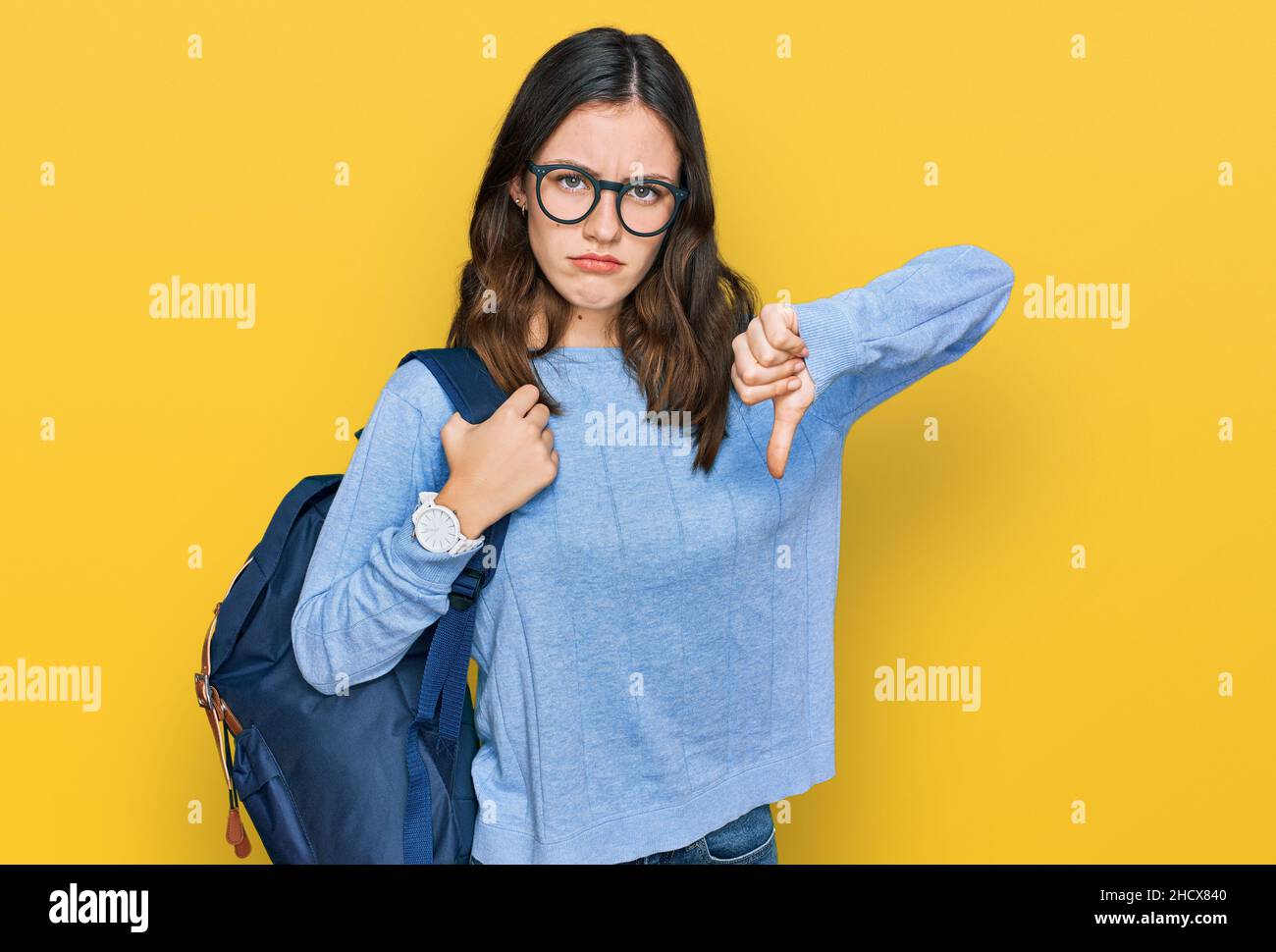 Young beautiful girl wearing student backpack with angry face, negative ...