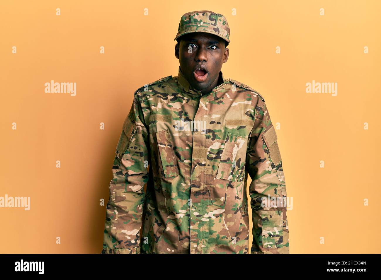Scared Army Young african american man wearing army uniform afraid and shocked with ...