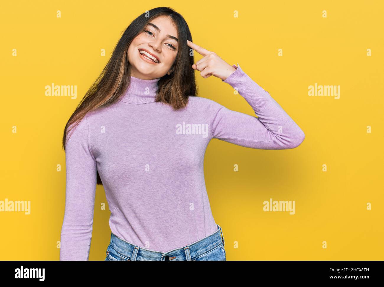 Young beautiful teen girl wearing turtleneck sweater smiling pointing ...