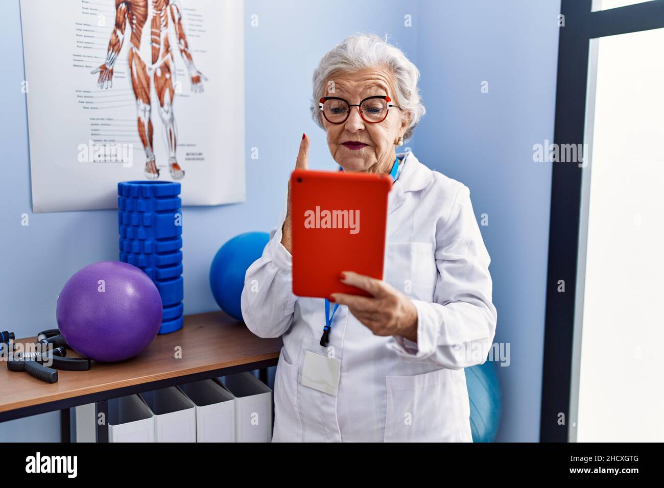 Senior female doctor doing video hi-res stock photography and images ...