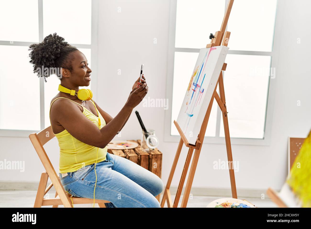 Young african american artist woman make photo to draw at art studio ...