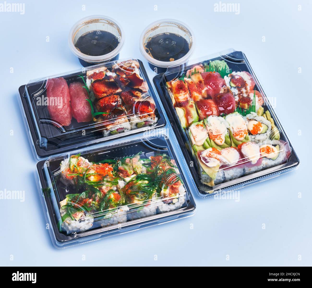 Delivery trays of sushi over blue background Stock Photo Alamy