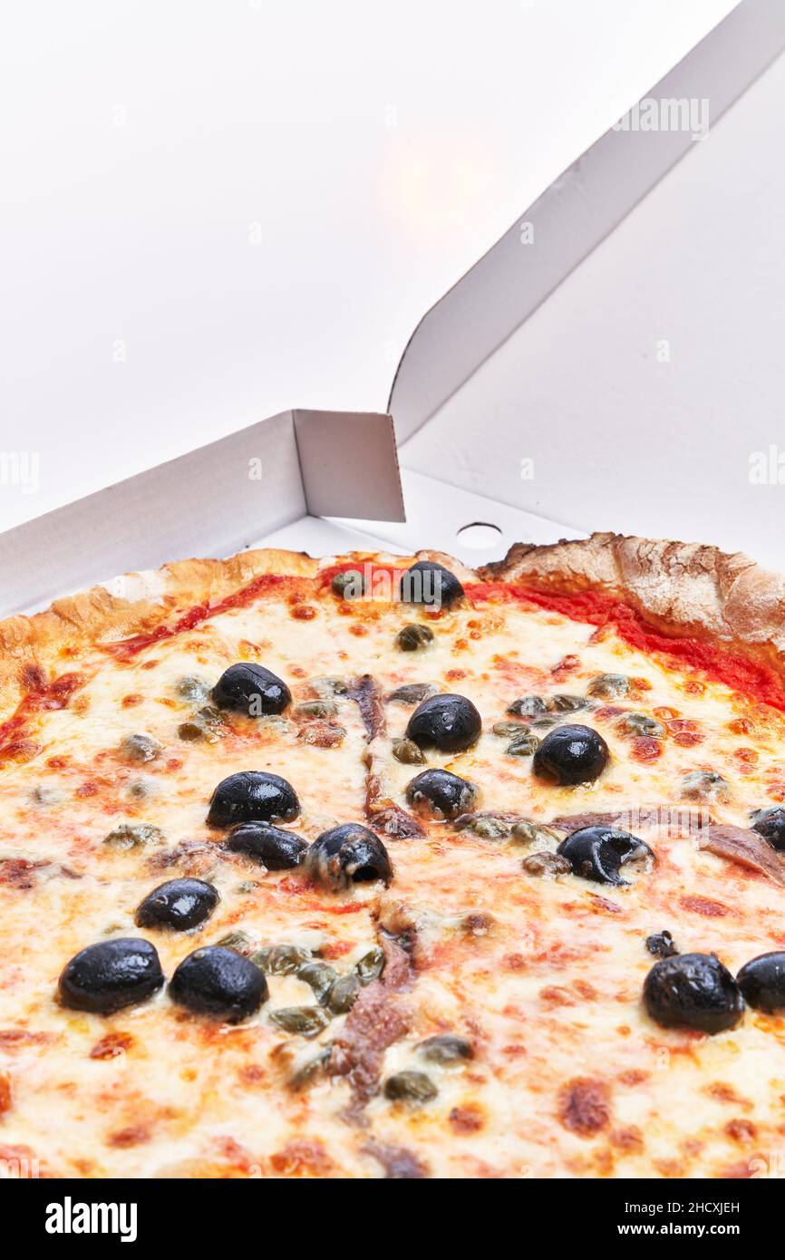 SIngle anchovies italian pizza on delivery box isolated over white