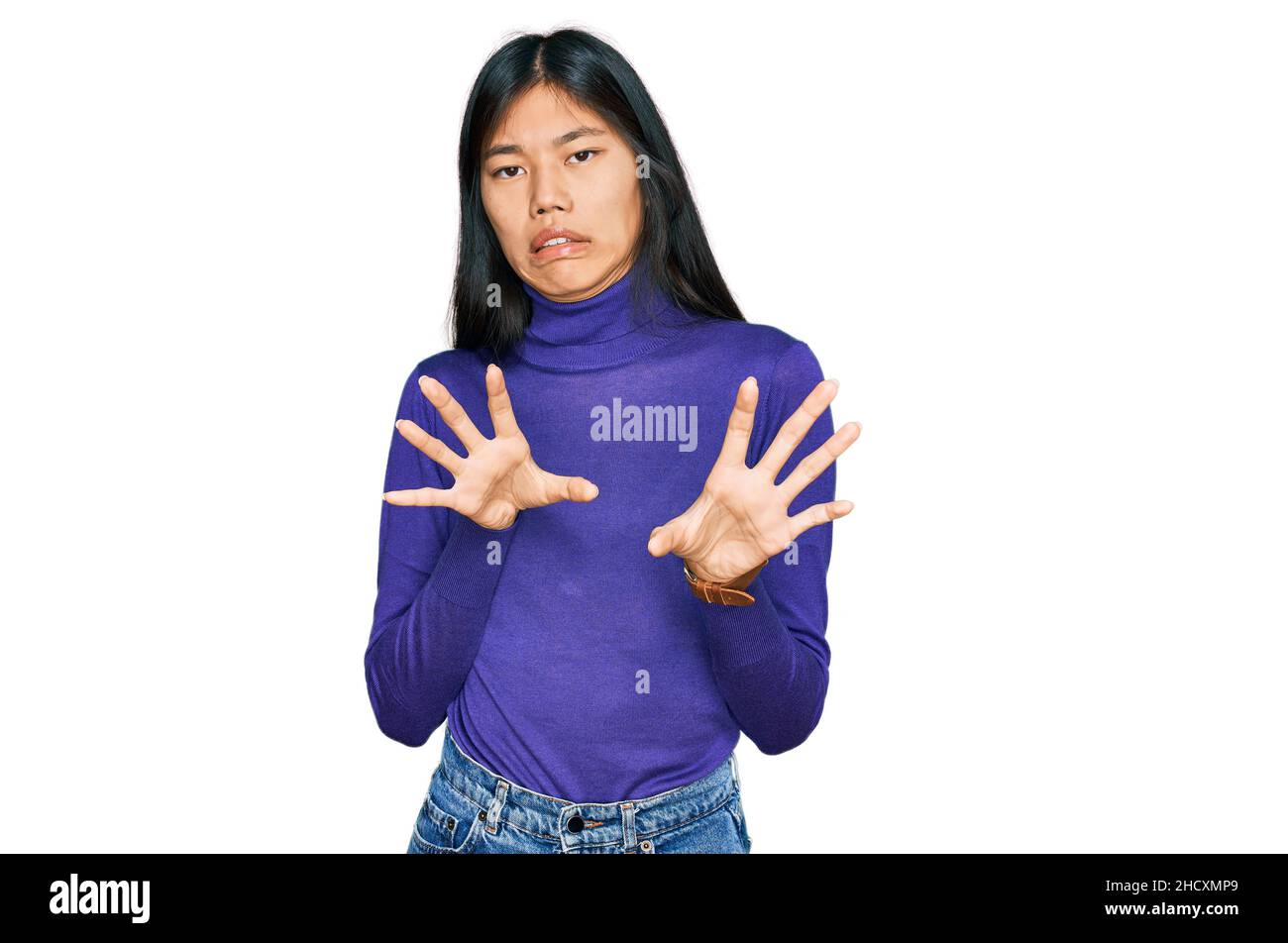 Beautiful young asian woman wearing casual clothes disgusted expression, displeased and fearful doing disgust face because aversion reaction. Stock Photo
