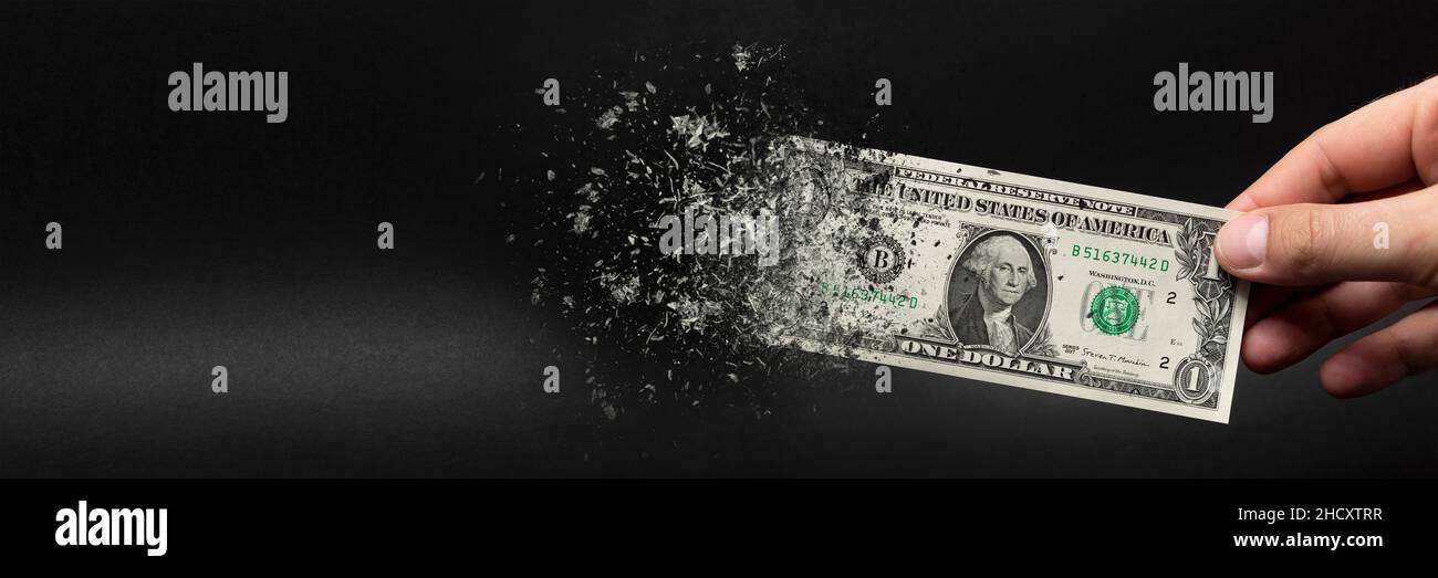 Inflation, dollar hyperinflation. Banner with black background. One dollar bill is sprayed in the hand of a man on a black background. The concept of Stock Photo
