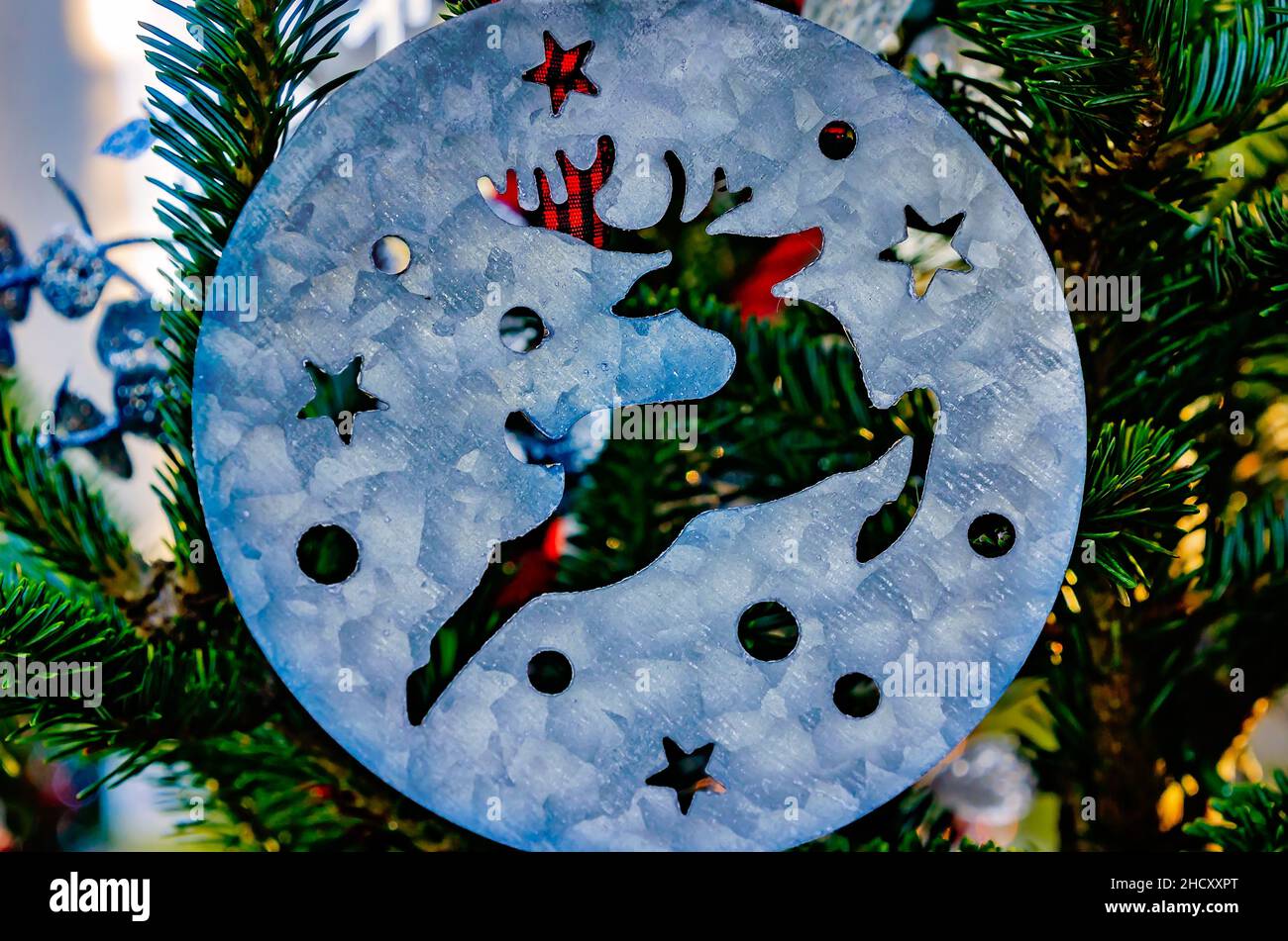 A metal reindeer Christmas ornament hangs on a Christmas tree, Dec. 24, 2021, in Dauphin Island, Alabama. Stock Photo