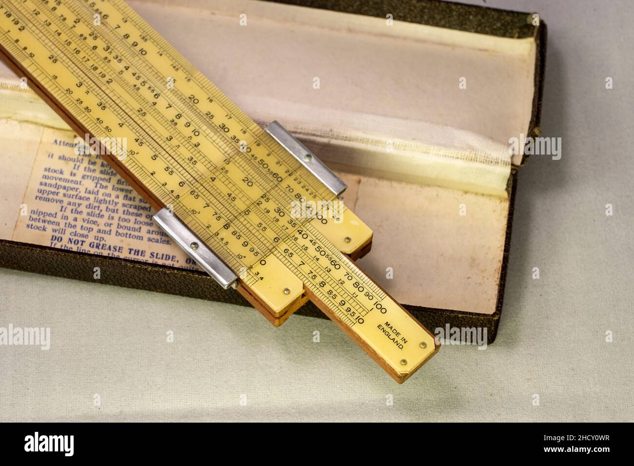 Old fashioned slide rule and box Stock Photo