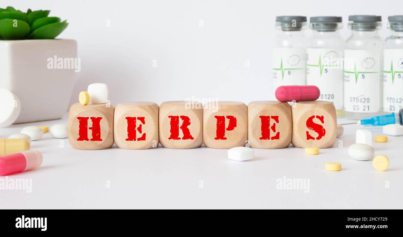Herpes - word from wooden blocks with letters, viral diseases herpes viruses concept, blue background. Stock Photo