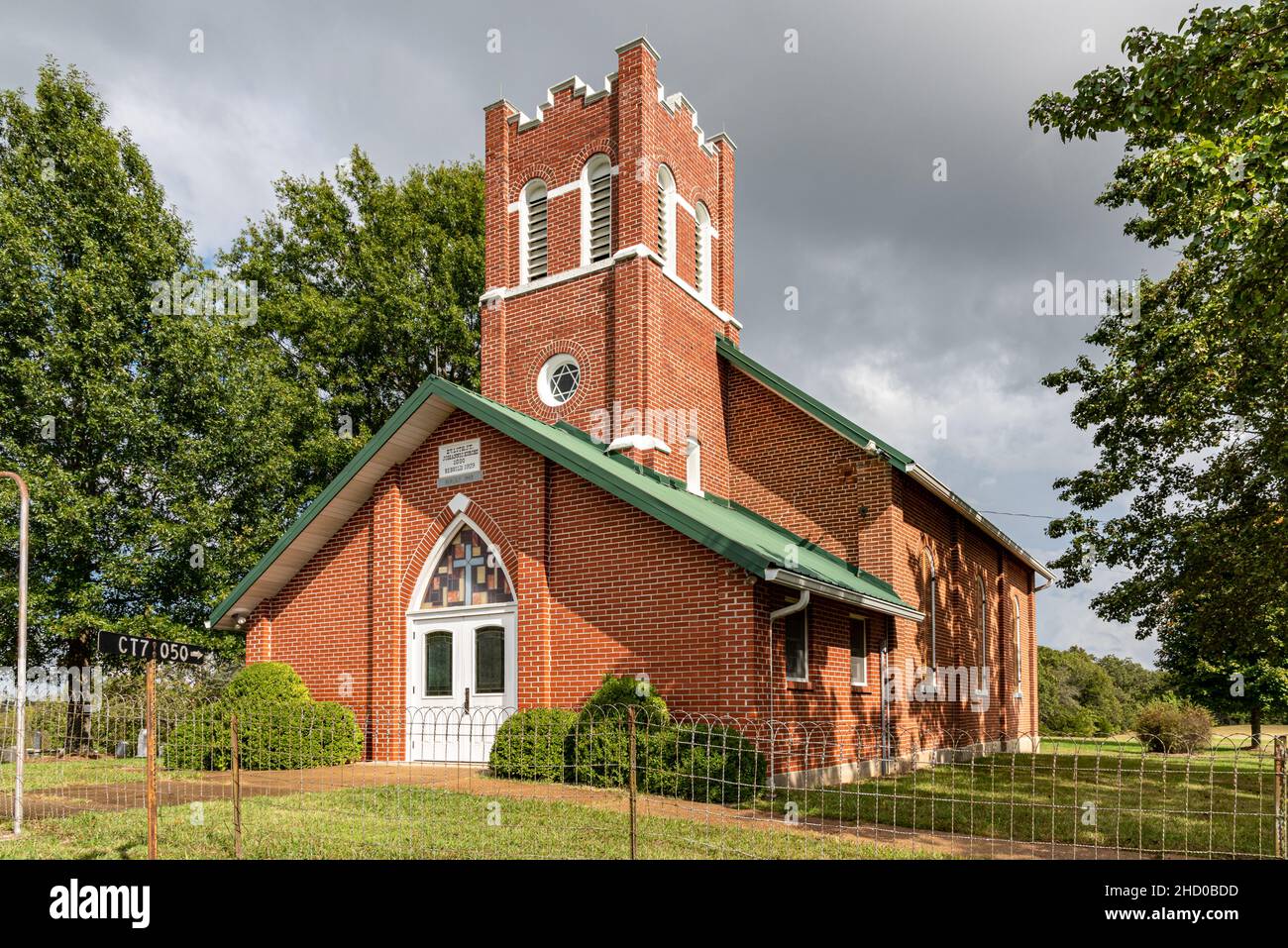St, John Lutheran Church in Owensville, Missouri, USA. The gothic revival structure has a square tower and is constructed from locally made red brick. Stock Photo