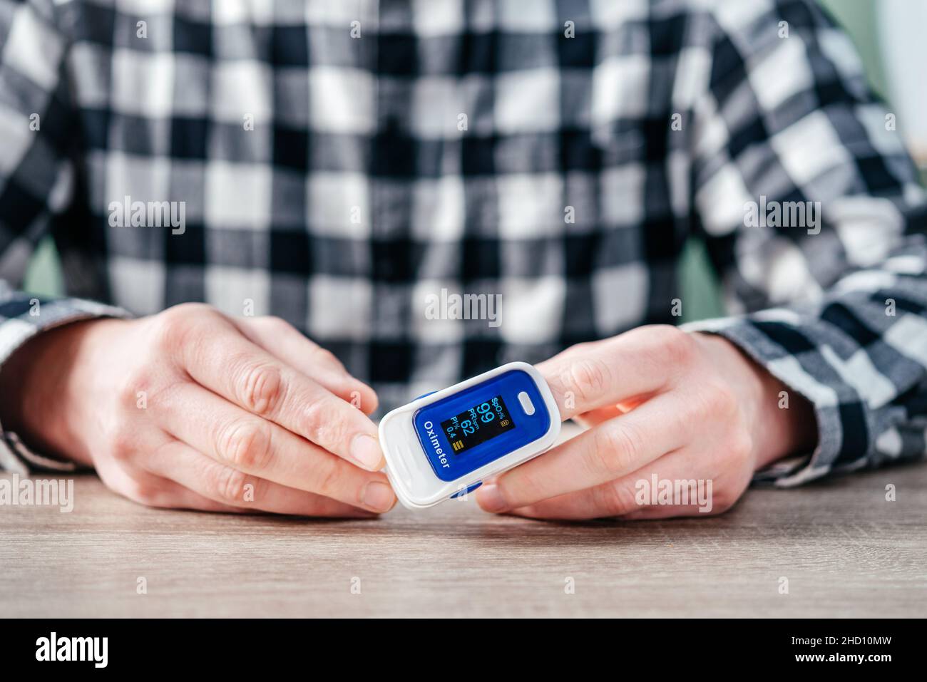A man checking oxygen level at home with home oximeter, patient