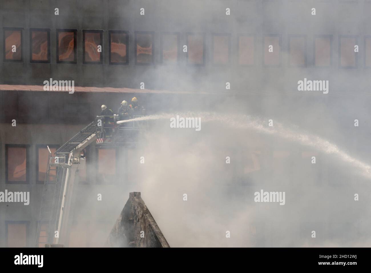 Firemen work at the parliament where a fire broke out in Cape Town, South Africa, January 2, 2022. REUTERS/Mike Hutchings Stock Photo